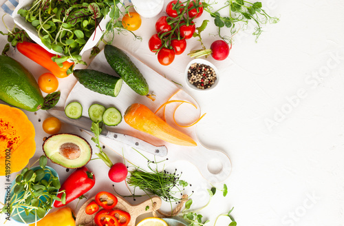  Fresh vegetables, fruits, microgreens and herbs for cooking healthy meals at home. Food frame with copy space, top view.