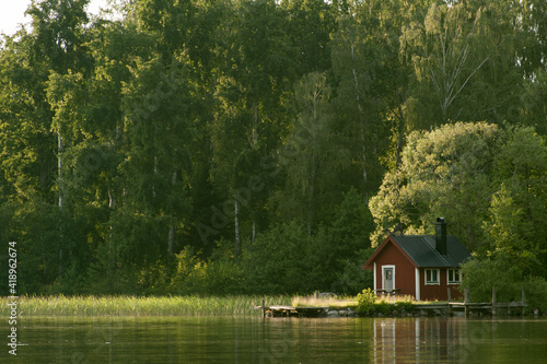 Romantic red house on a lake in Sweden