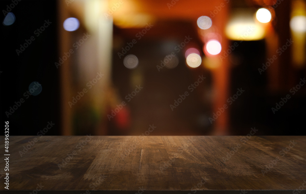 Empty dark wooden table in front of abstract blurred bokeh background of restaurant . can be used for display or montage your products.Mock up for space. Empty dark wooden table in front of abstract blurred bokeh background of restaurant . can be used for display or montage your products.Mock up for space.