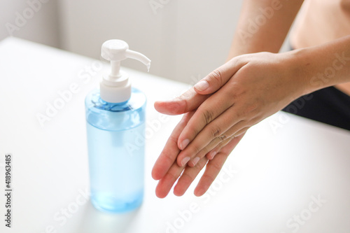 Hand applying Alcohol gel sanitazer liquid cleaning hands for prevent corona virus covid-19.