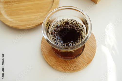 Very bubbly aerated coffee in a glass. Manual brewing, third wave specialty concept photo