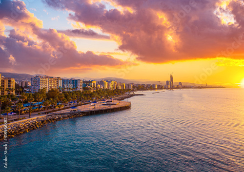Sunset in Cyprus. View of Limassol coast at sunset. View of Limassol from the top. Promenade of the Mediterranean sea. Parasailing over the Mediterranean. Parachuting. Evening landscape of Cyprus.