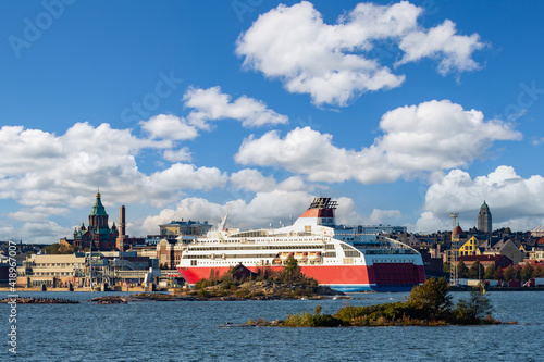 Helsinki. Finland. A cruise liner in the harbour of Helsinki.  Baltic sea. Gulf of Finland. The big ship is heading for the dock. Assumption Cathedral in Helsinki. Cruises on the liner.