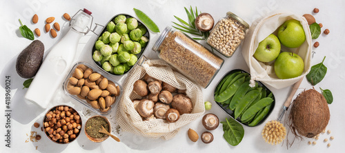 Fototapeta Naklejka Na Ścianę i Meble -  Zero waste concept. Eco bags with fruits and vegetables and glass jars . Eco-friendly shopping and cooking concept, flat lay