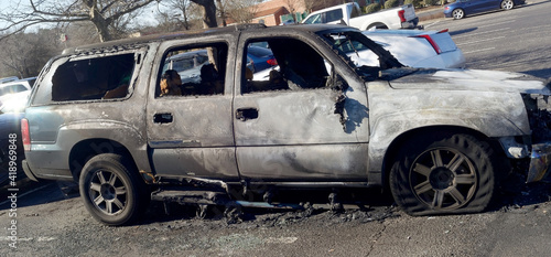 Canvas Print Burned car abandoned in parking lot.