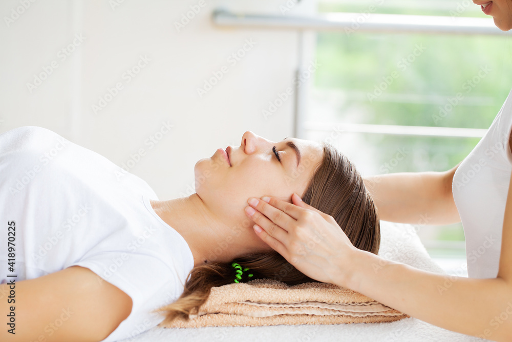 Beautiful young woman relaxing with hand massage at beauty spa salon. Beautiful young woman relaxing with hand massage at beauty spa salon.