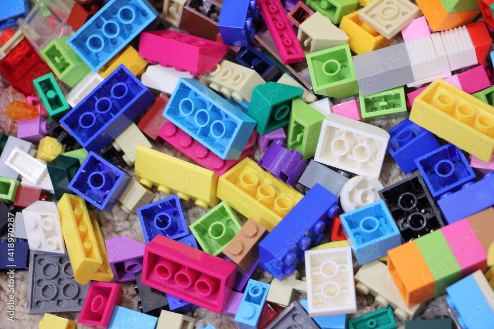 A lot colorful construction blocks from the children's model kit, close up top view texture for background A lot colorful construction blocks from the children's model kit, close up top view texture for background