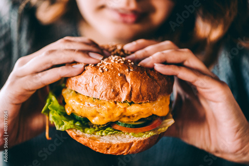person eating  cheeseburger
