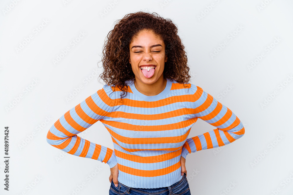 Young african american woman isolated on white background funny and friendly sticking out tongue. Young african american woman isolated on white background funny and friendly sticking out tongue.