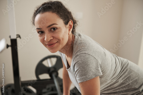 African young woman looking at camera during functional training in gym at home