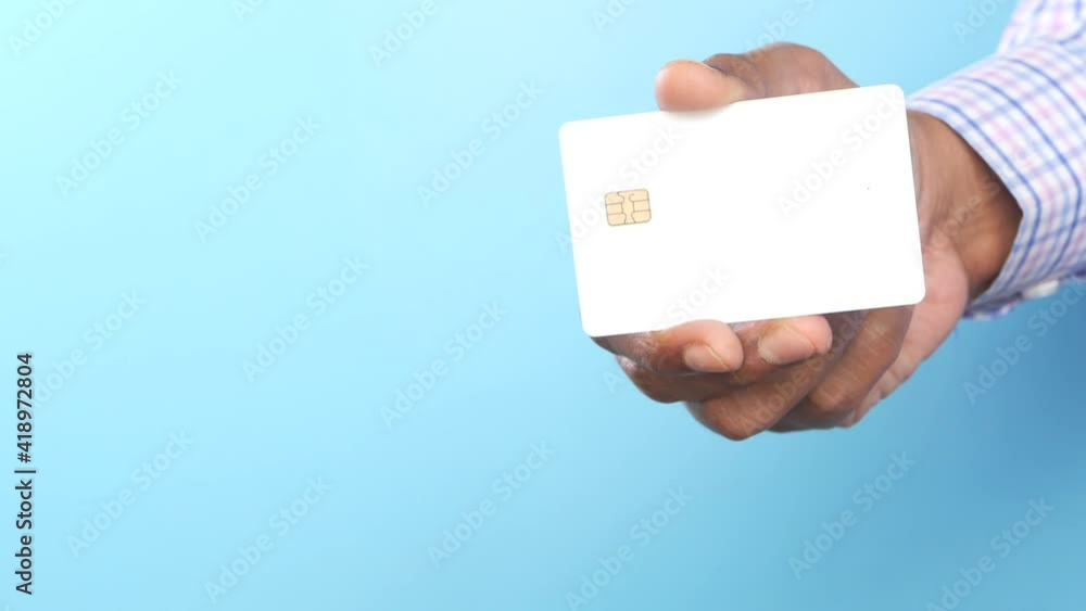 man hand showing credit card against blue background man hand showing credit card against blue background