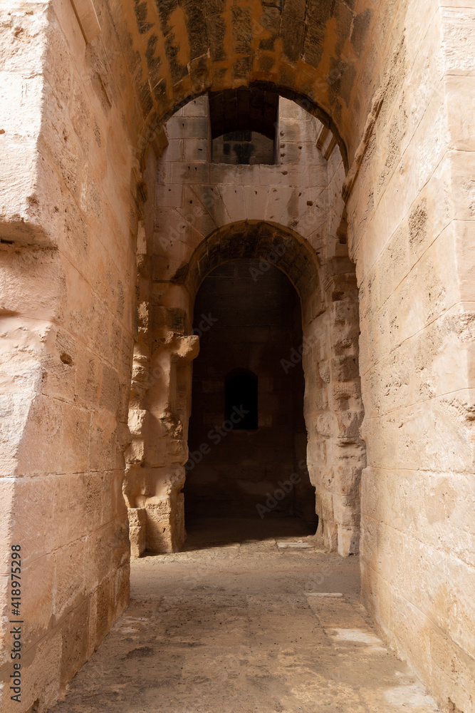 Vaulted corridor leading into the darkness of the  Amphitheatre of El Jem, Tunisia.