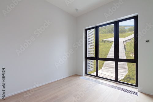 Empty loft room with white home walls and glass window with green nature view and wood floor 3D Render