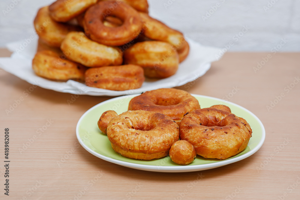 Traditional pastries. Homemade donuts. Photo 6: finished fried donuts are stacked on a plate.