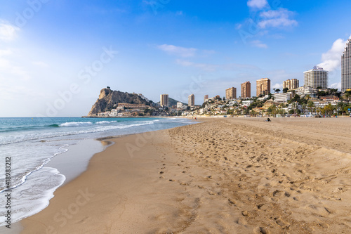 the empty beach at La Cala and Benidorm with its hotels and high-rise building skyline behind © makasana photo