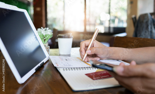 Focus on male hand putting signature contract on credit card statement