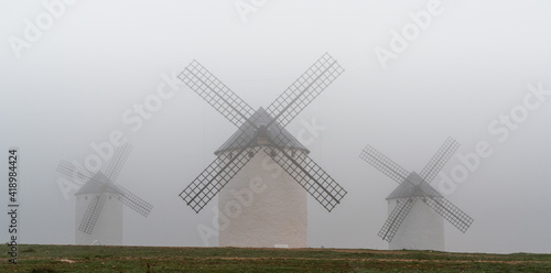 view of the windmills of Campo de Criptana in La Mancha on a very foggy morning