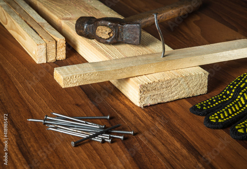 Carpenter workplace tools and wood planks. Working environment in a carpentry workshop photo