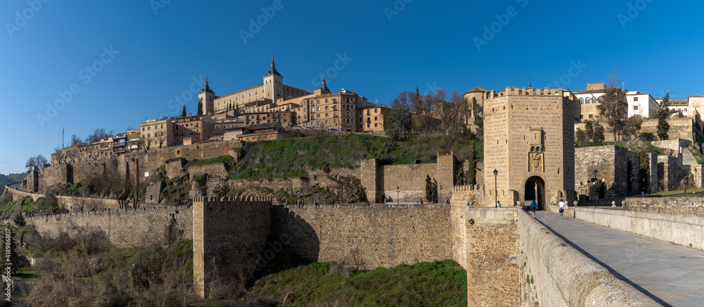 panorama of the historic Spanish city of Toledo on the Tagus River with the Roman Bridge in the foreground