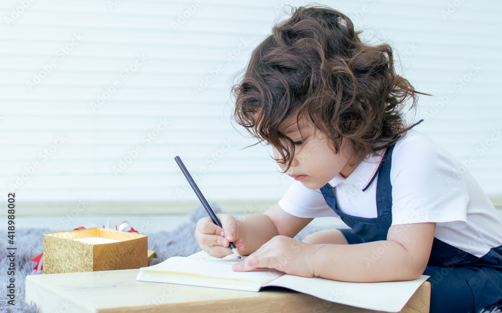 Portrait of little girl writing and drawing on paper Portrait of little girl writing and drawing on paper