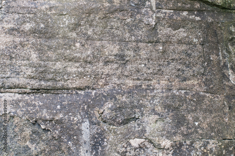 Heavily textured dark grey rocky surface with prominent horizontal lines and cracks. For use as a graphic element, a background, wallpaper or overlay layer.