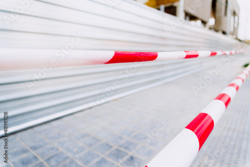 White and red plastic security tapes prevent access to a construction site. © Joaquin Corbalan