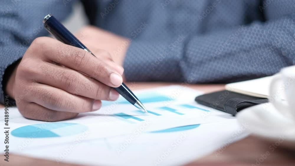 man hand with pen analyzing bar chart on paper man hand with pen analyzing bar chart on paper