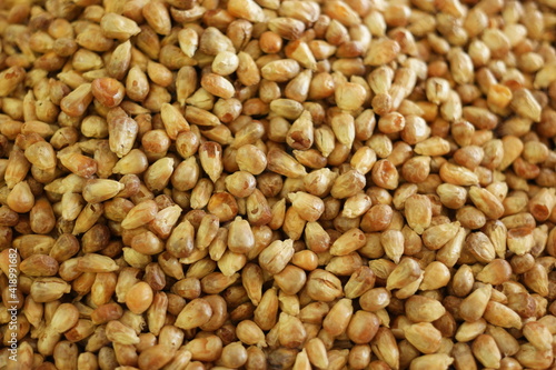 Heap of peeled peanuts close up. Roasted peeled peanuts background.