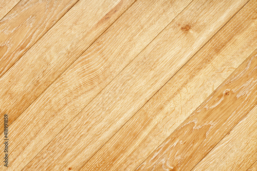 Beautiful texture of natural light oak planks arranged diagonally.