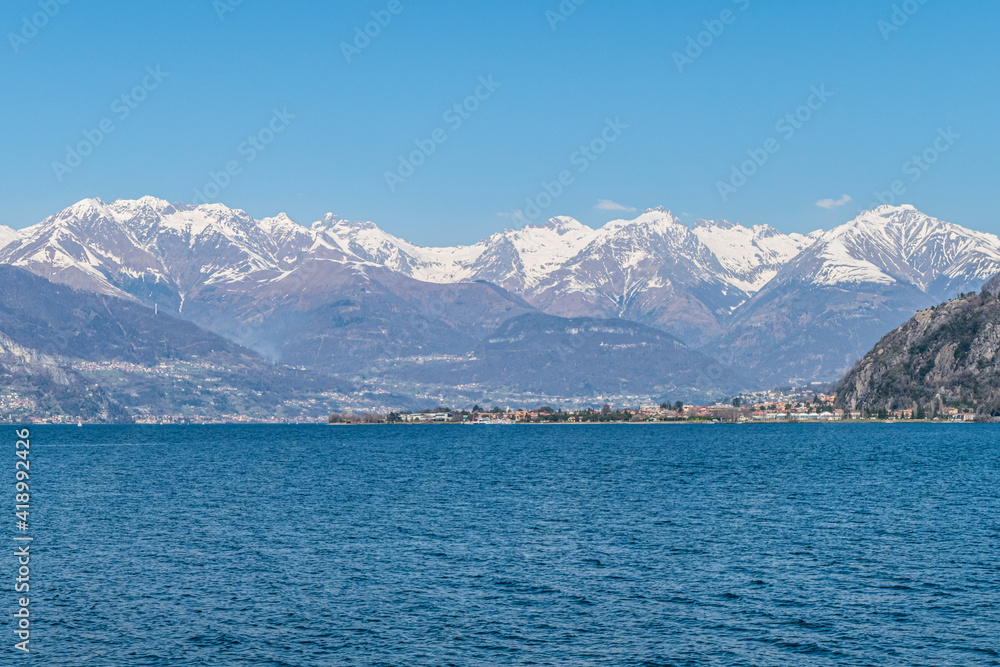Landscape of the Lake of Coo with Dervio and the Alps in background