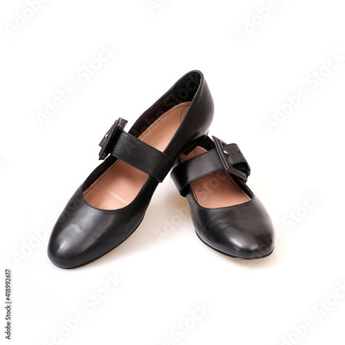 Black leather beautiful low-heeled black shoes isolated on white background