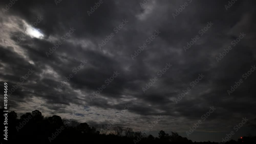 Moonlight through clouds during incoming winter storm, time lapse Moonlight through clouds during incoming winter storm, time lapse