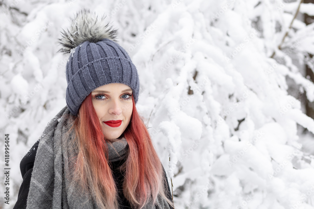 Portrait of smiling red hair and red lips girl in snowy day. Horizontally. Portrait of smiling red hair and red lips girl in snowy day. Horizontally.