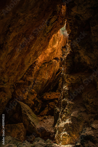 Light illuminating a hidden limestone cave in Gozo, Malta