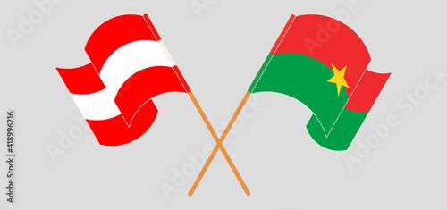Crossed and waving flags of Austria and Burkina Faso