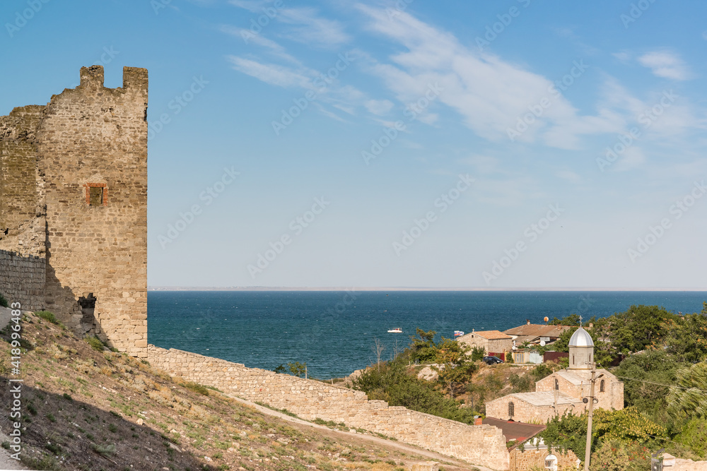 Medieval fortress of Kafa on the shore of the Gulf of Feodosia. Tourist attraction the resort town. View of the Temple of the Iveron Icon of the Mother of God