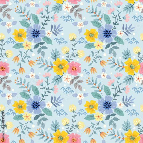 Colorful flowers on a light blue color seamless pattern for fabric textile background.