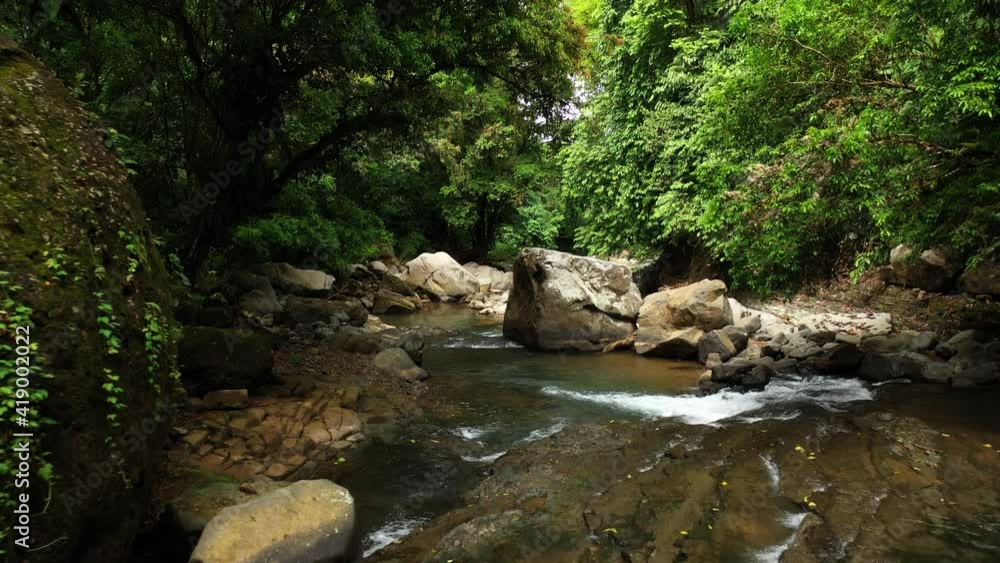 flying over a river with giant rocks in a tropical forest Costa Rica nauyaca falls flying over a river with giant rocks in a tropical forest Costa Rica nauyaca falls