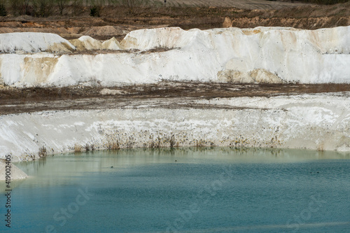 Large sand pit and lake. A flooded old abandoned quarry complex. Extraction of sand and stone for industrial applications.