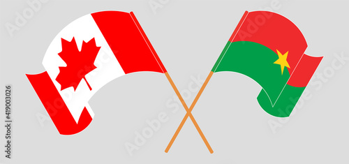 Crossed and waving flags of Canada and Burkina Faso