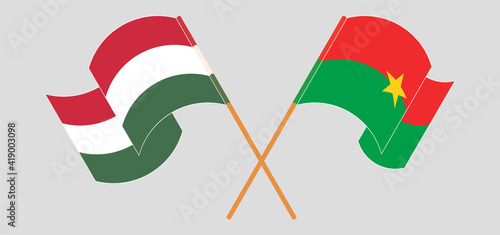 Crossed and waving flags of Hungary and Burkina Faso