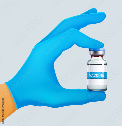 Doctor hand, in a blue disposable Nitrile Glove holding ampoule with a vaccine for coronavirus covid-19. Vaccination and immunization concept
