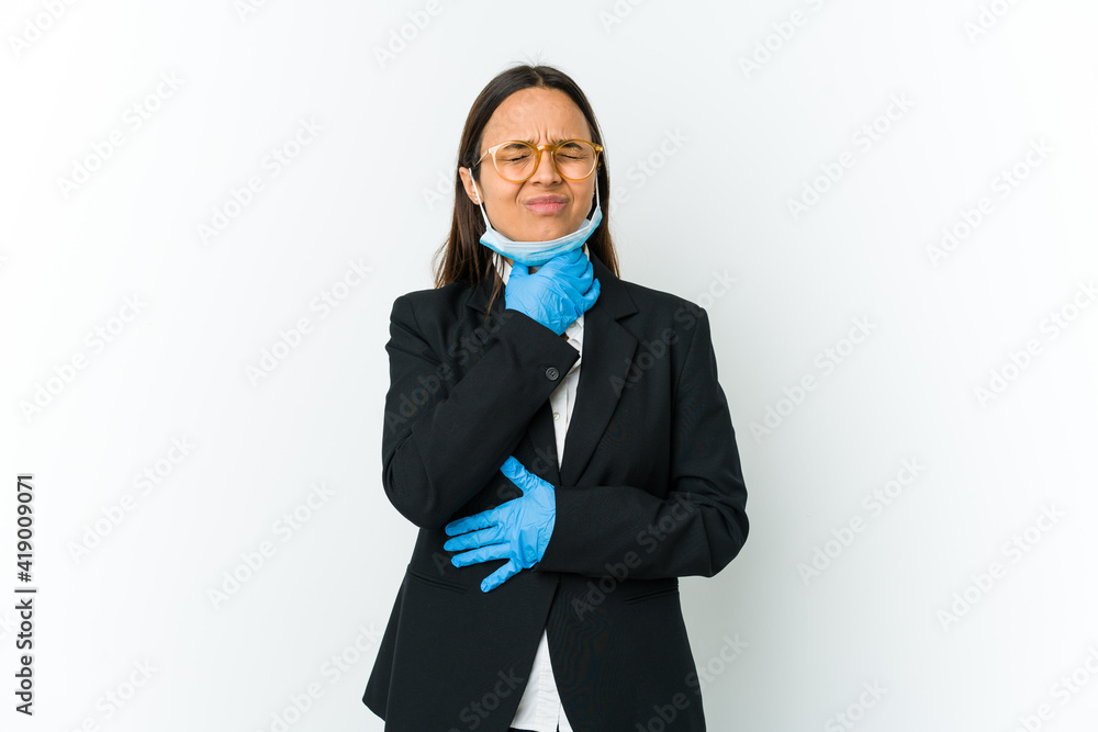 Young business latin woman wearing a mask to protect from covid isolated on white background suffers pain in throat due a virus or infection. Young business latin woman wearing a mask to protect from covid isolated on white background suffers pain in throat due a virus or infection.