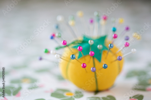 yellow pin cushion with colorful pins 3 photo