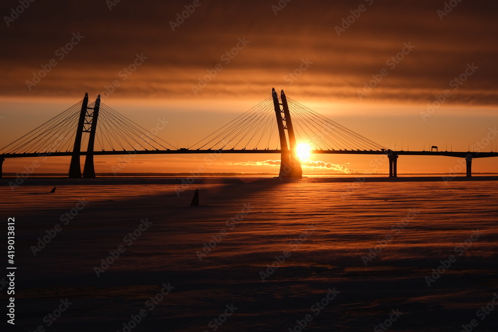 winter sunset on the background of the bridge