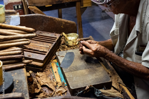 Older man working in tobacco factory, making cigars in Havana © Xavi