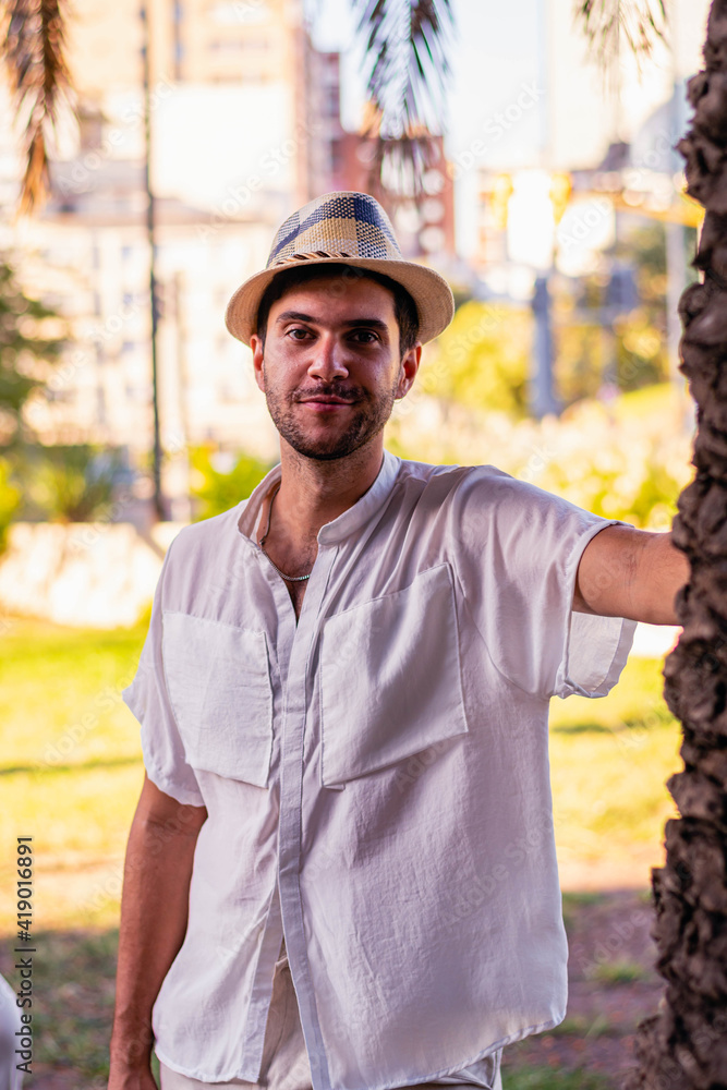 young man in outdoor city park wearing white and light clothes in spring summer 2021 young man in outdoor city park wearing white and light clothes in spring summer 2021