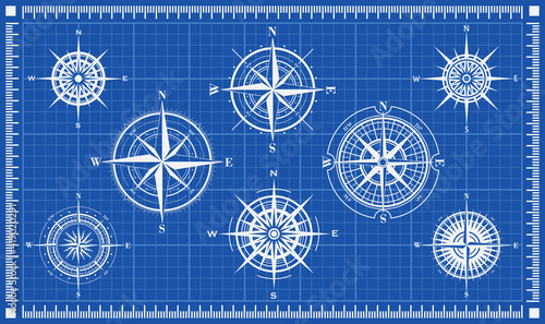 Set of isolated white marine wind roses silhouettes on blue background. Compass vector navigation symbol illustrations. Elements for design. Blueprint background. Vector illustration.