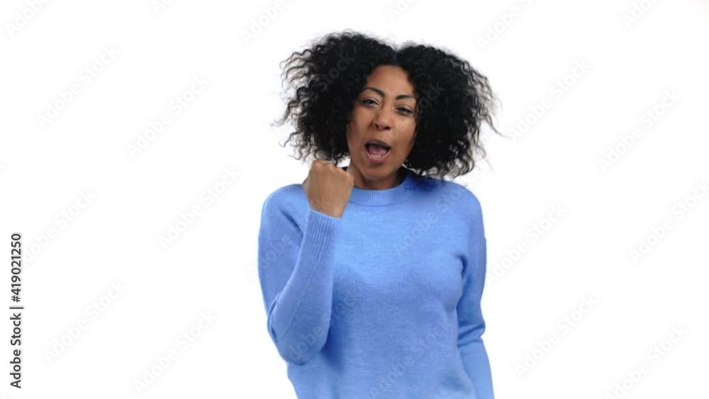 African woman is very glad and happy, she shows yes gesture of victory, she achieved result, goals. Surprised excited happy lady on white studio background. Jackpot concept. African woman is very glad and happy, she shows yes gesture of victory, she achieved result, goals. Surprised excited happy lady on white studio background. Jackpot concept.
