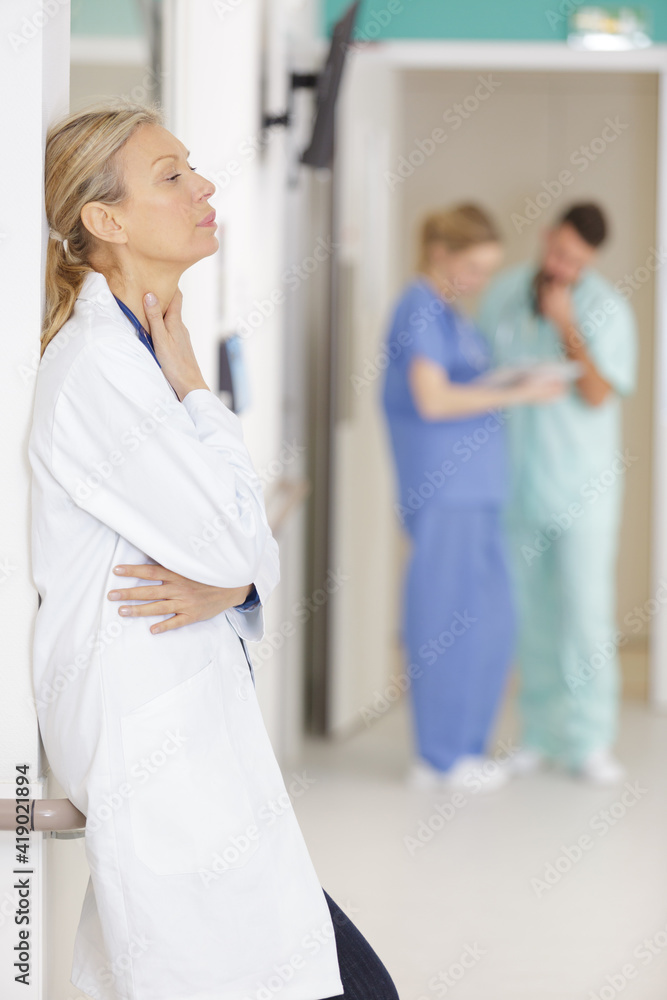 Obraz premium portrait of senior female doctor on hospital corridor relaxing